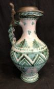 A faience pottery claret jug