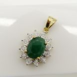 Emerald and diamond cluster pendant in 9ct yellow gold.