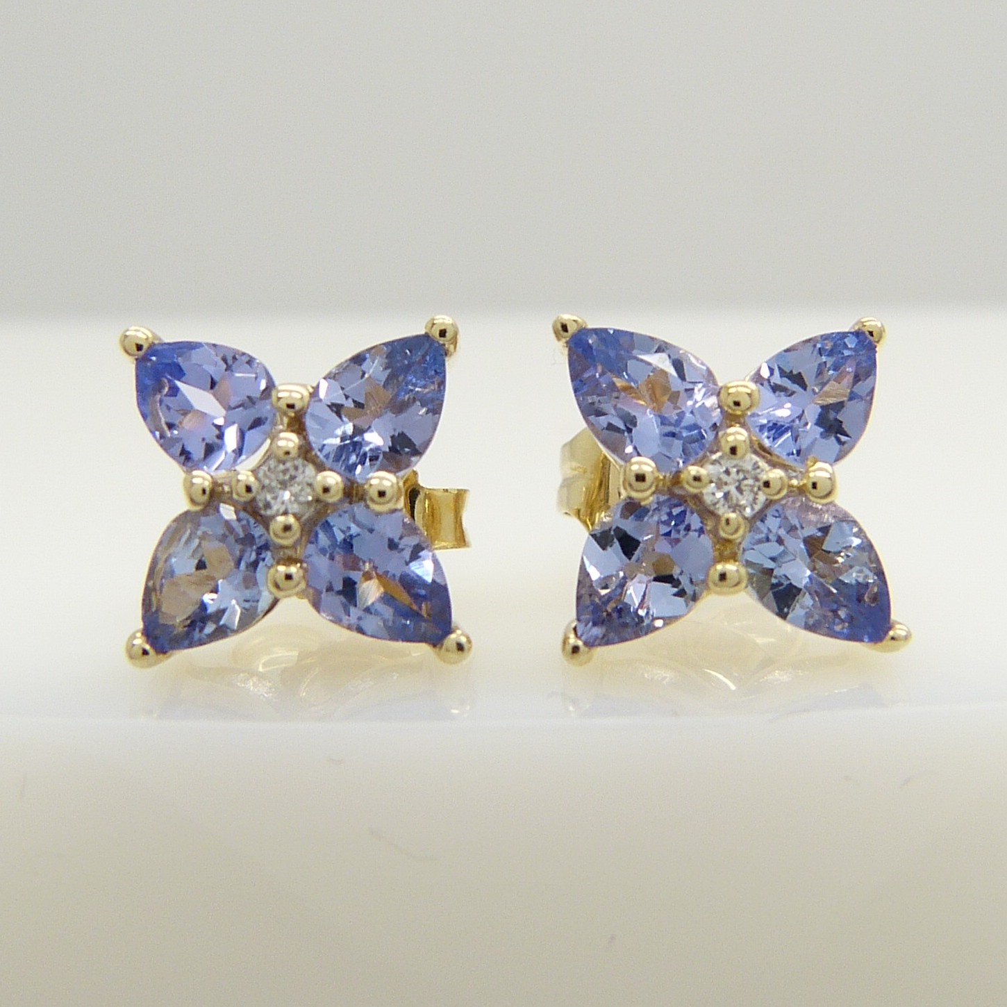 9ct yellow gold tanzanite and diamond stud earrings, boxed.