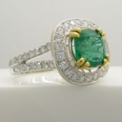 Stylish 14ct white gold emerald and diamond ring with diamond-set halo and shoulders.