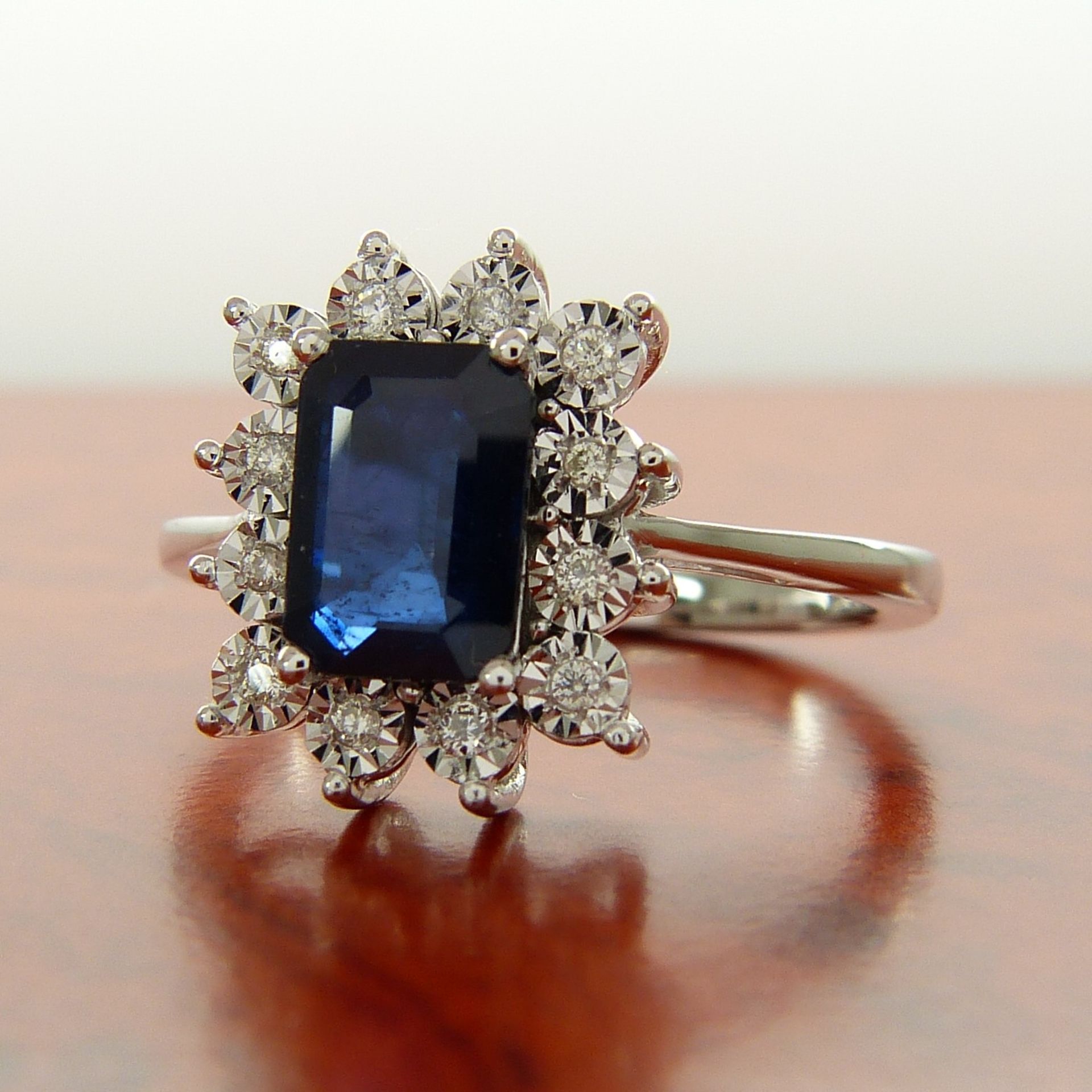 A rectangular treated 0.85 carat sapphire and diamond cluster ring in 9ct white gold - Image 2 of 7
