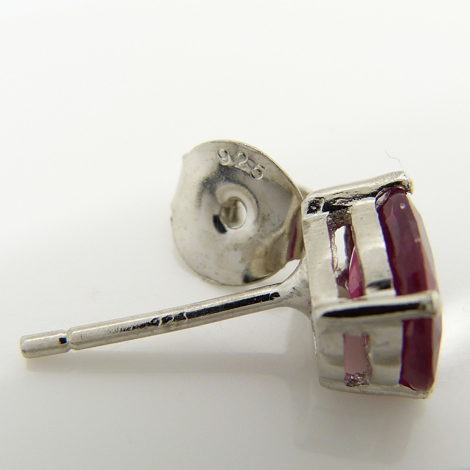 A pair of silver ear studs set with treated rubies, 1.70 carats (approx) - Image 5 of 5