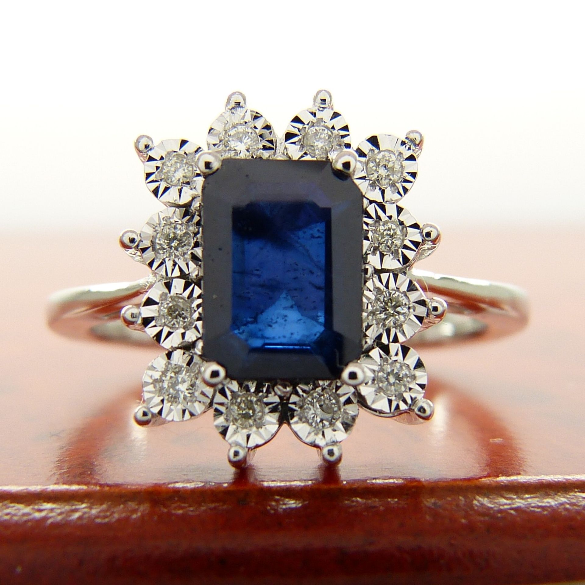 A rectangular treated 0.85 carat sapphire and diamond cluster ring in 9ct white gold - Image 3 of 7