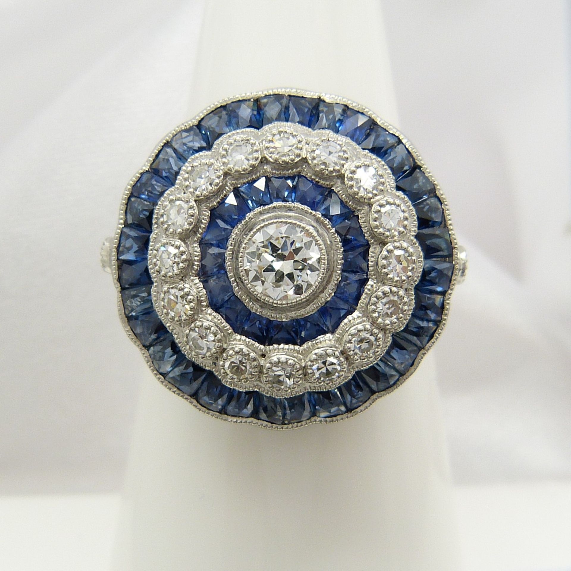 A large platinum floral-style diamond and sapphire cocktail ring