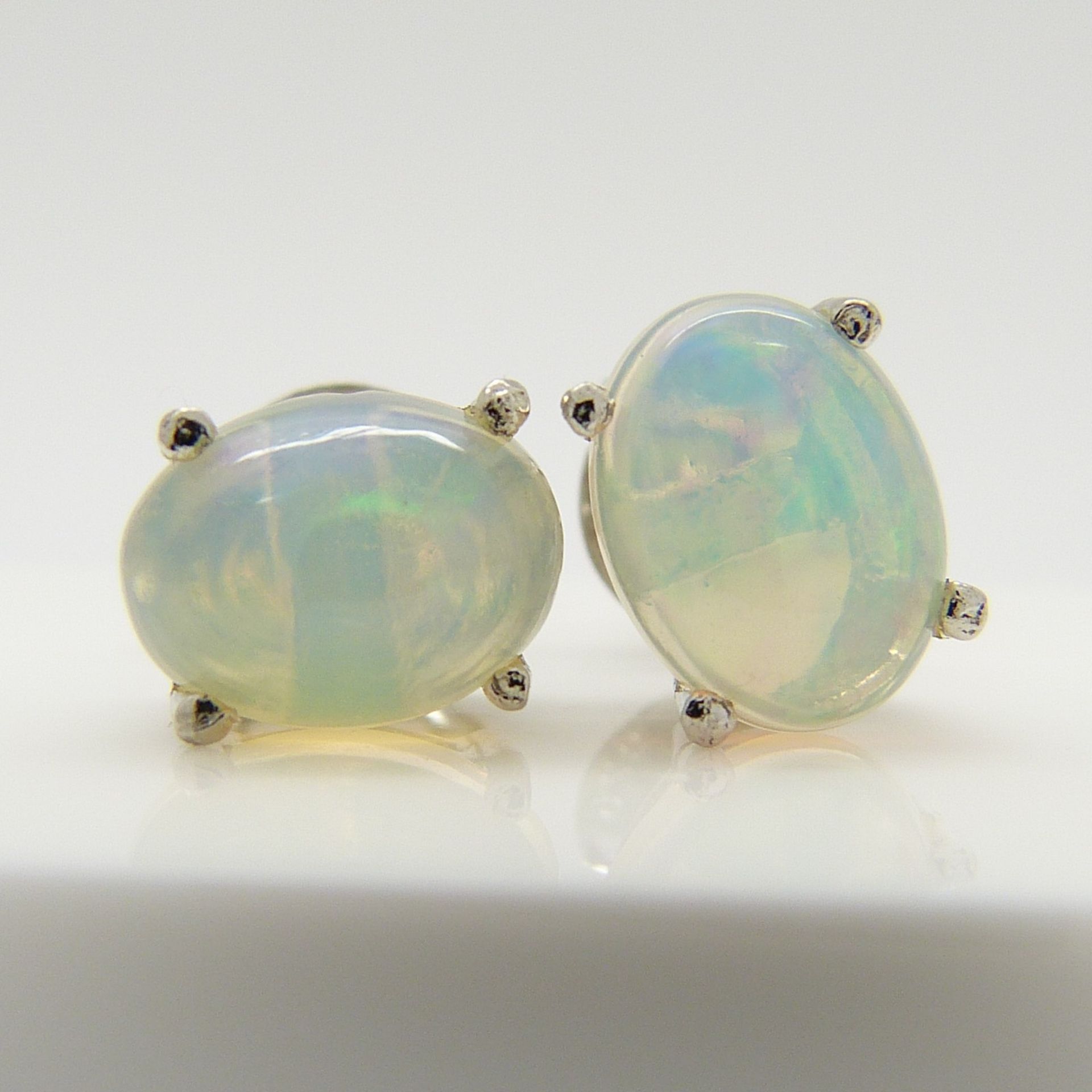 A pair of silver ear studs set with cabochon white opals, 1.30 carats (approx) - Image 2 of 5