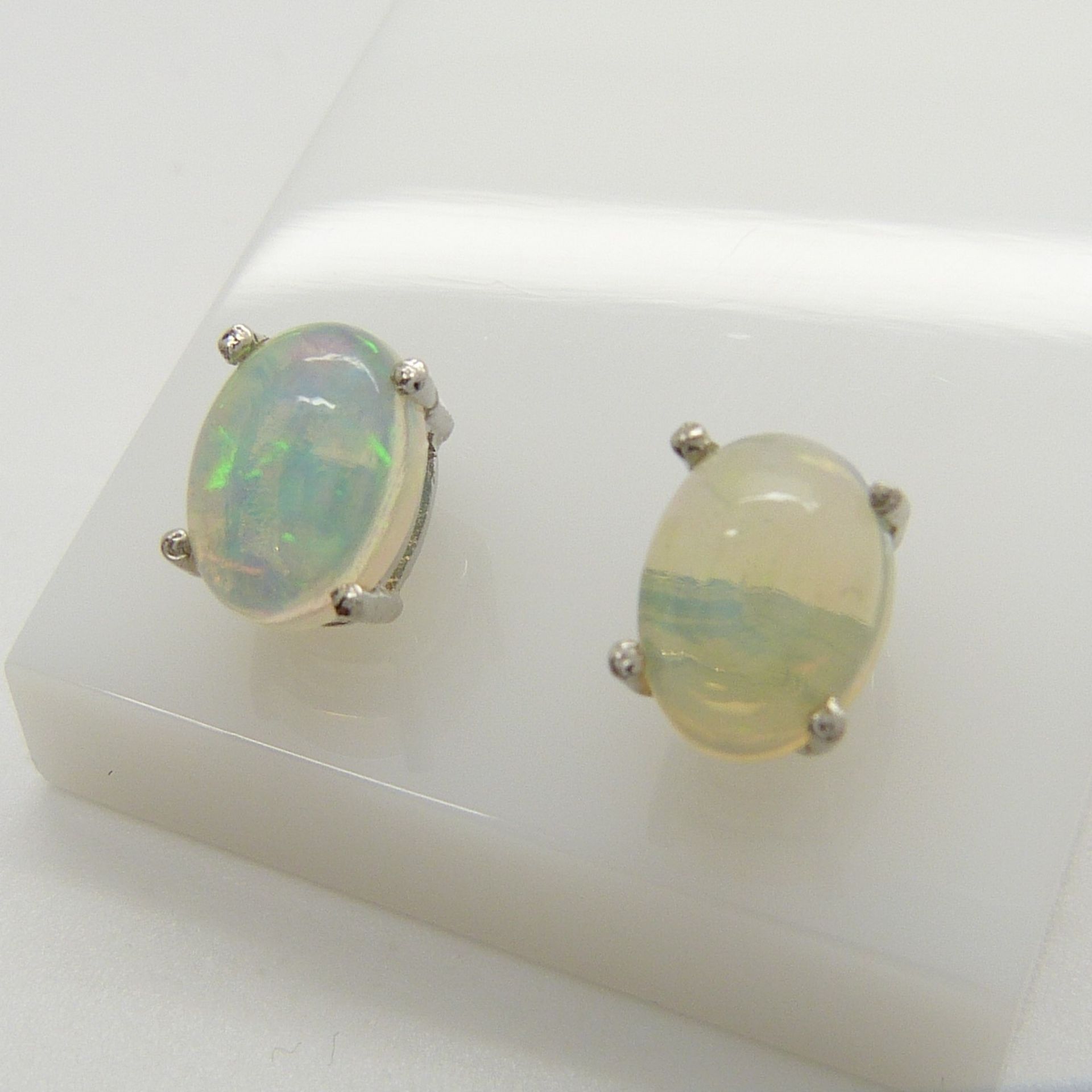 A pair of silver ear studs set with cabochon white opals, 1.30 carats (approx) - Image 4 of 5