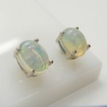 A pair of silver ear studs set with cabochon white opals, 1.30 carats (approx)