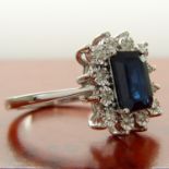 A rectangular treated 0.85 carat sapphire and diamond cluster ring in 9ct white gold