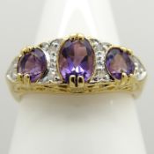 A Victorian-style dress ring set with amethysts and diamonds in 9ct yellow gold
