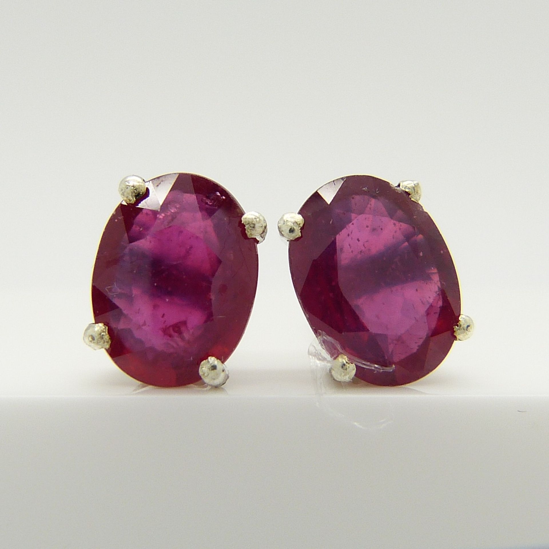 A pair of silver ear studs set with treated rubies, 1.70 carats (approx)