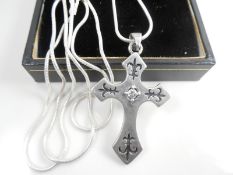 Silver necklace with pendant cross.