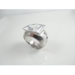Silver ring with white stone.