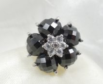 Flower-shaped onyx silver ring.