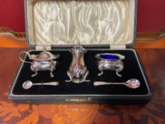 Silver set for condiments with two spoons.