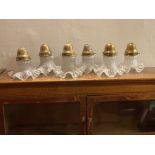 Six Edwardian glass shades with brass holders