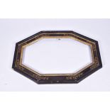 An ebonised and gilt decorated wooden framewith canted corners