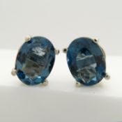 A pair of London blue topaz silver ear studs with butterfly backs.