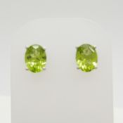 A pair of silver stud earrings set with peridots, 2.00 carats (approx).