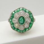 A daisy-style platinum emerald and old-cut diamond ring.