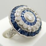 A large platinum floral-style diamond and sapphire cocktail ring.