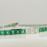 Stylish 18ct white gold line bracelet set with princess-cut emeralds and princess-cut diamonds.