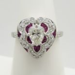 Victorian-style 18ct white gold heart-shaped ring set with a central pear-cut diamond and rubies