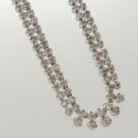 A weighty 5.08 carat diamond Riviere double droplet-style necklace in platinum, boxed.
