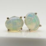 A pair of silver ear studs set with cabochon white opals, 1.30 carats (approx).