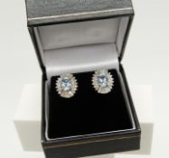 A stunning pair of 18ct white gold Art Deco-style aquamarine and diamond halo ear studs, boxed.