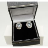 A stunning pair of 18ct white gold Art Deco-style aquamarine and diamond halo ear studs, boxed.