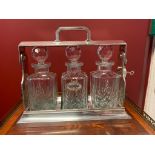 Silver-plated tantalus with three cut crystal decanters