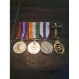 FOUR MINIATURE MILITARY MEDALS ON A BAR