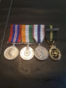 FOUR MINIATURE MILITARY MEDALS ON A BAR