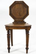 A 19th century oak hall chair, with octagonal back, solid seat and turned legs