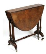 A Victorian figured walnut oval Sutherland table on turned supports