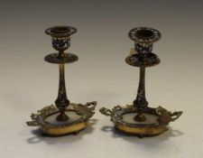 Pair of Continental gilt metal champlevé and alabaster candlesticks,