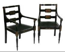 A pair of Regency style ebonised and painted carver chairs