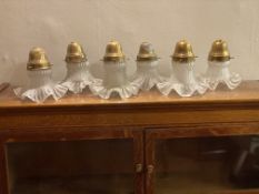 Six Edwardian glass shades with brass holders