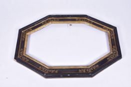 An ebonised and gilt decorated wooden framewith canted corners