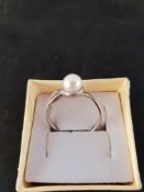 Silver Ring with a Simulated Pearl Stone.