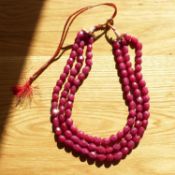 A necklace strung with 3 strands of oval faceted earth mined rubies, 927.50 carats