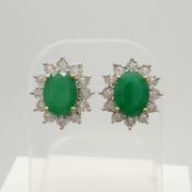 A striking pair of 9ct yellow gold treated emerald and diamond cluster earrings, boxed