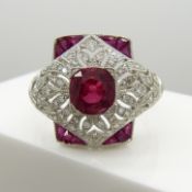 A platinum Victorian-style dress ring set with rubies and diamonds in a pierced, ornate setting