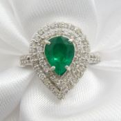 A stunning pear-cut emerald and double diamond halo ring, with diamond-set shoulders