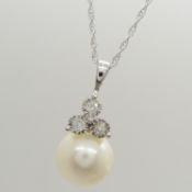 A 9ct white gold chain with diamond and pearl pendant, boxed
