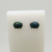 A pair of silver ear studs set with cabochon black Ethiopian opals, 1.10 carats (approx).