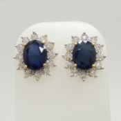 A stunning pair of 9ct yellow gold treated blue sapphire and diamond cluster ear studs, boxed.