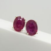 A pair of silver ear studs set with treated rubies, 1.70 carats (approx)