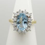 A sparkling 18ct white and yellow gold aquamarine and diamond cluster ring
