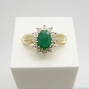 A 9ct yellow gold oval-cut emerald and 12 diamond cluster ring